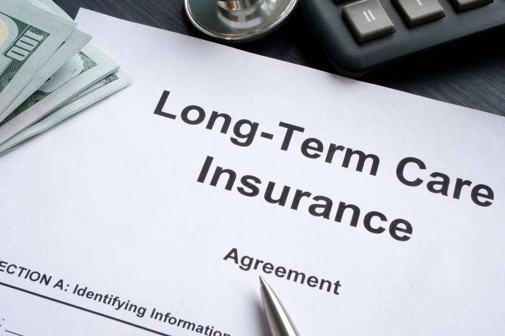 LTC Long-Term care insurance agreement and a pen.